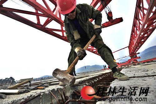 千秋漓江大桥上的工人挥舞铁锤,努力工作